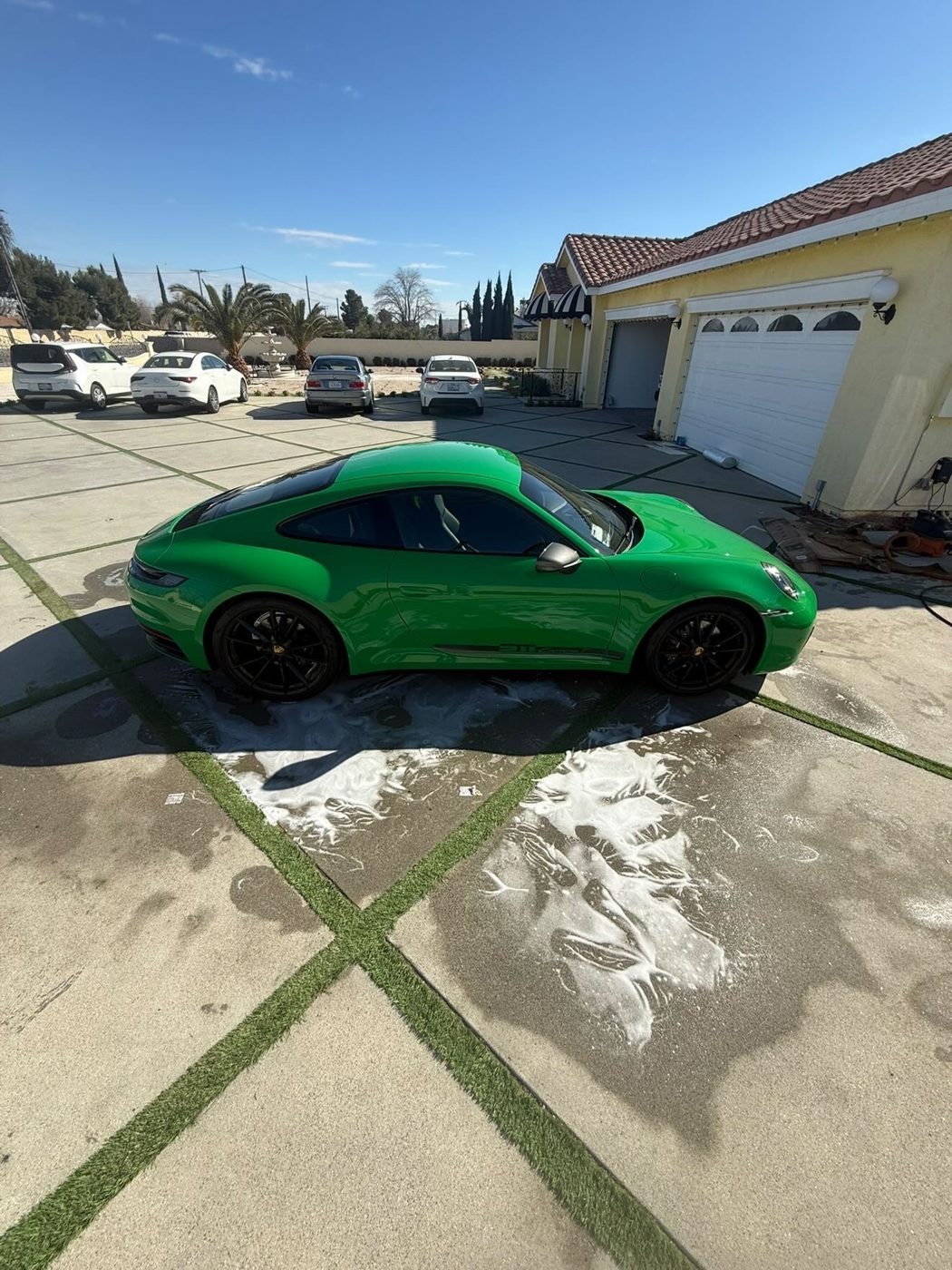Custom green Porsche 911 detailed in the driveway